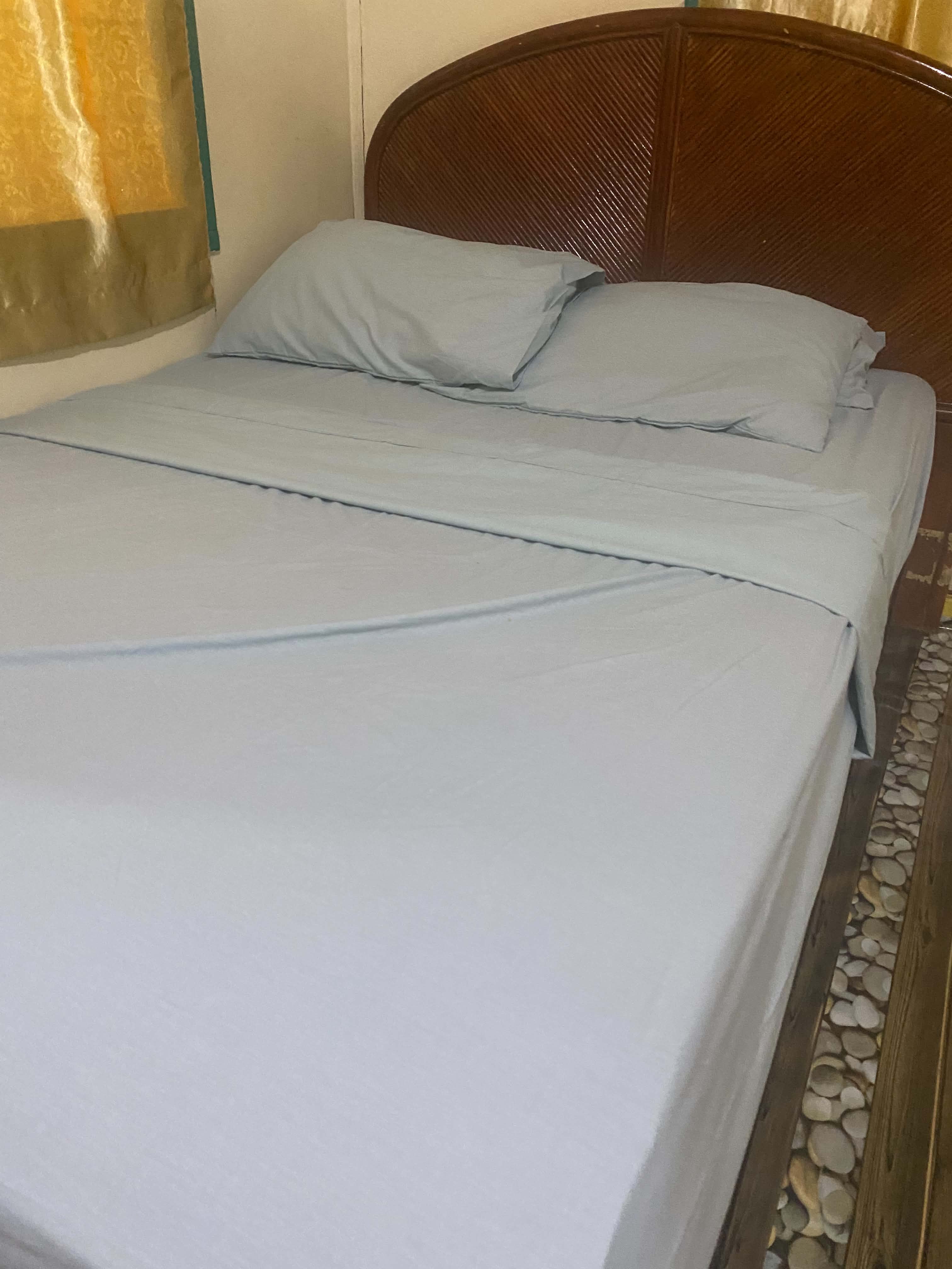 Double bed with white bedding in a Livingstone guest room